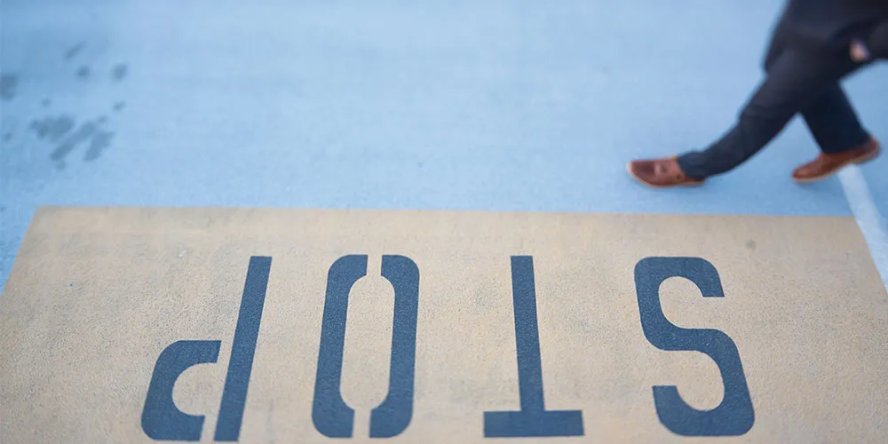 Red stop sign against a rural backdrop